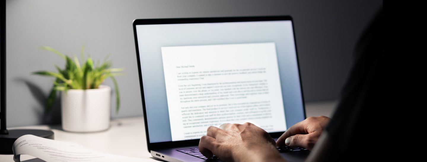 Stemp back view of person in home office writing cover letter