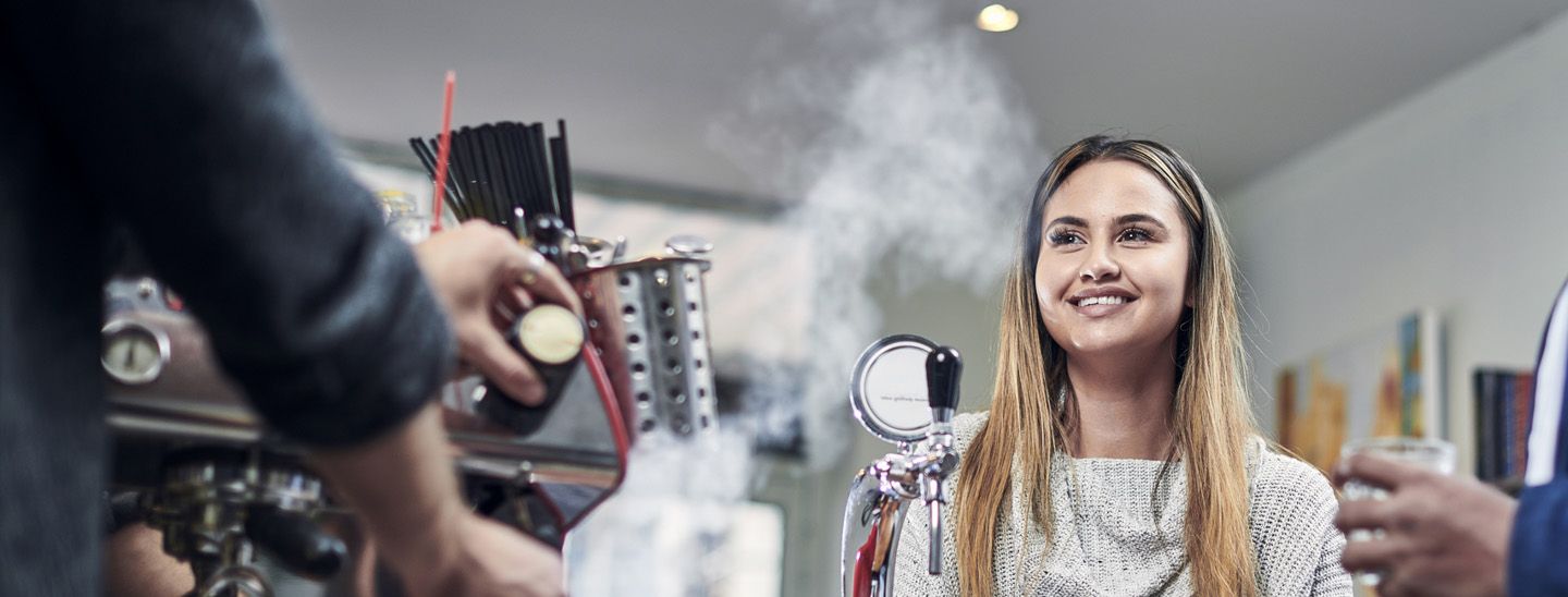 Stemp content worker smiles at her cafe job