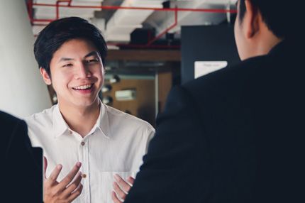 Stemp enthusiastic young man asks questions during job interview