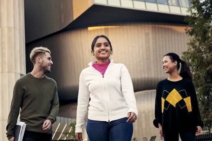 Stemp happy mixed students walking on campus