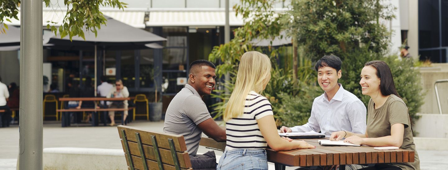 Stemp mixed group of students on campus collaborate outdoors