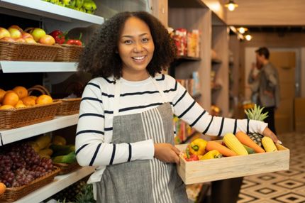 Stemp smiling grocery store worker poses for photo