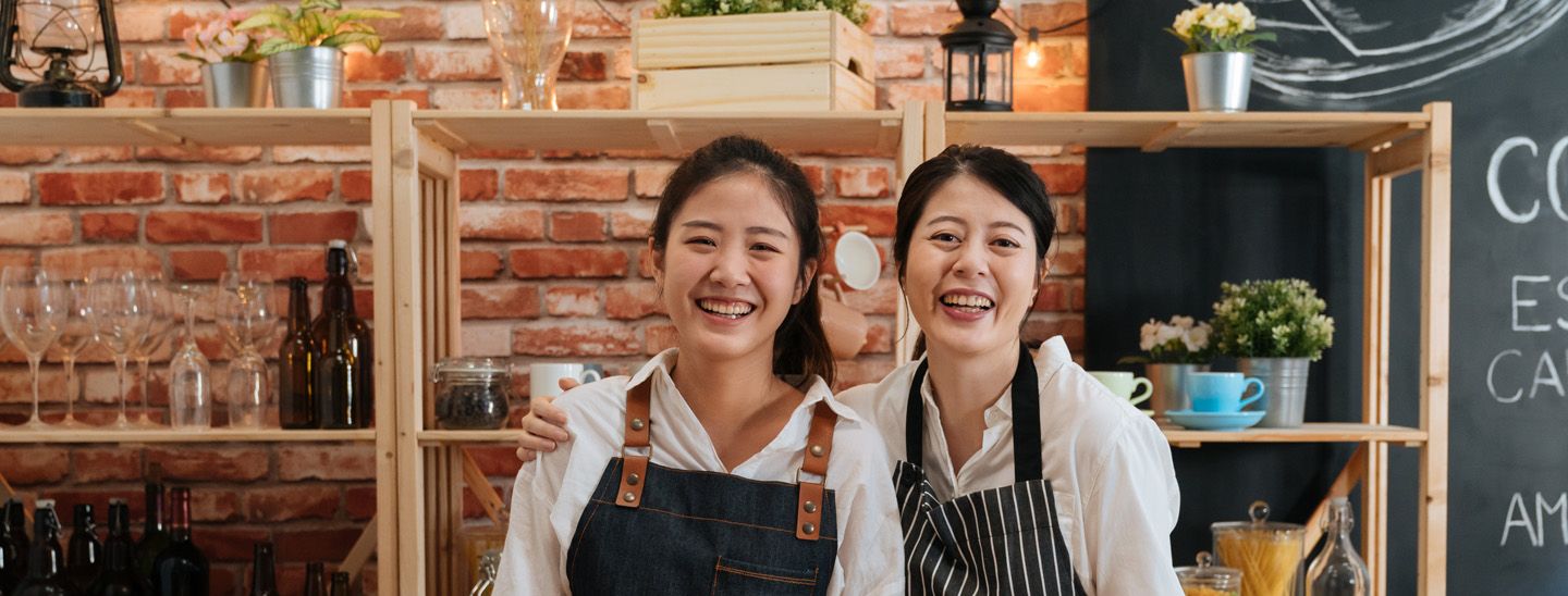 Stemp two smiling cafe workers take break for photo
