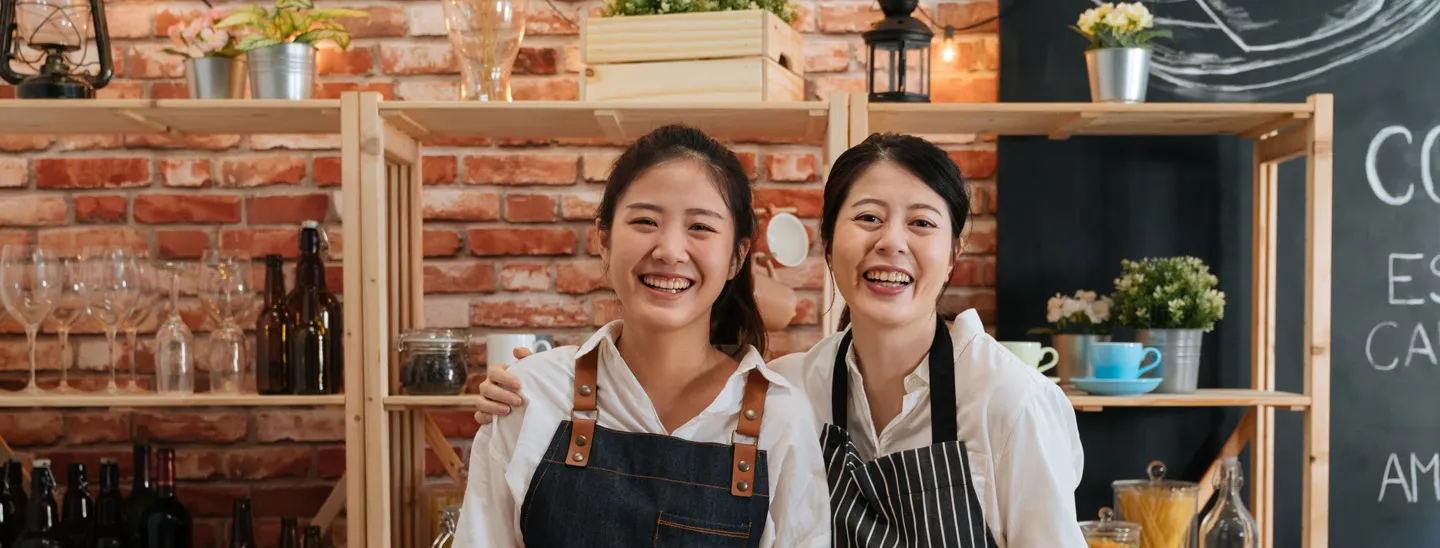 Stemp two smiling cafe workers take break for photo