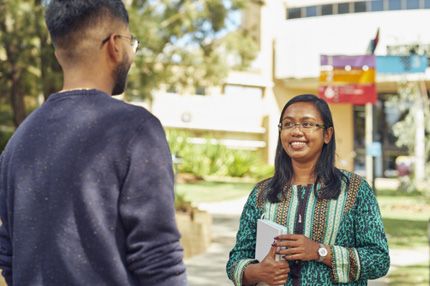 Stemp two students catch up outdoors on campus