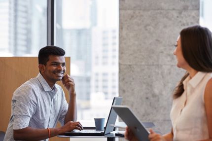 Campus couple in cafe with laptops