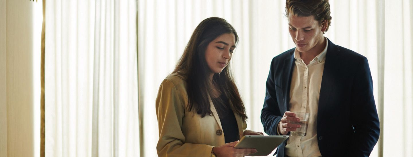 Campus couple looking at tablet device