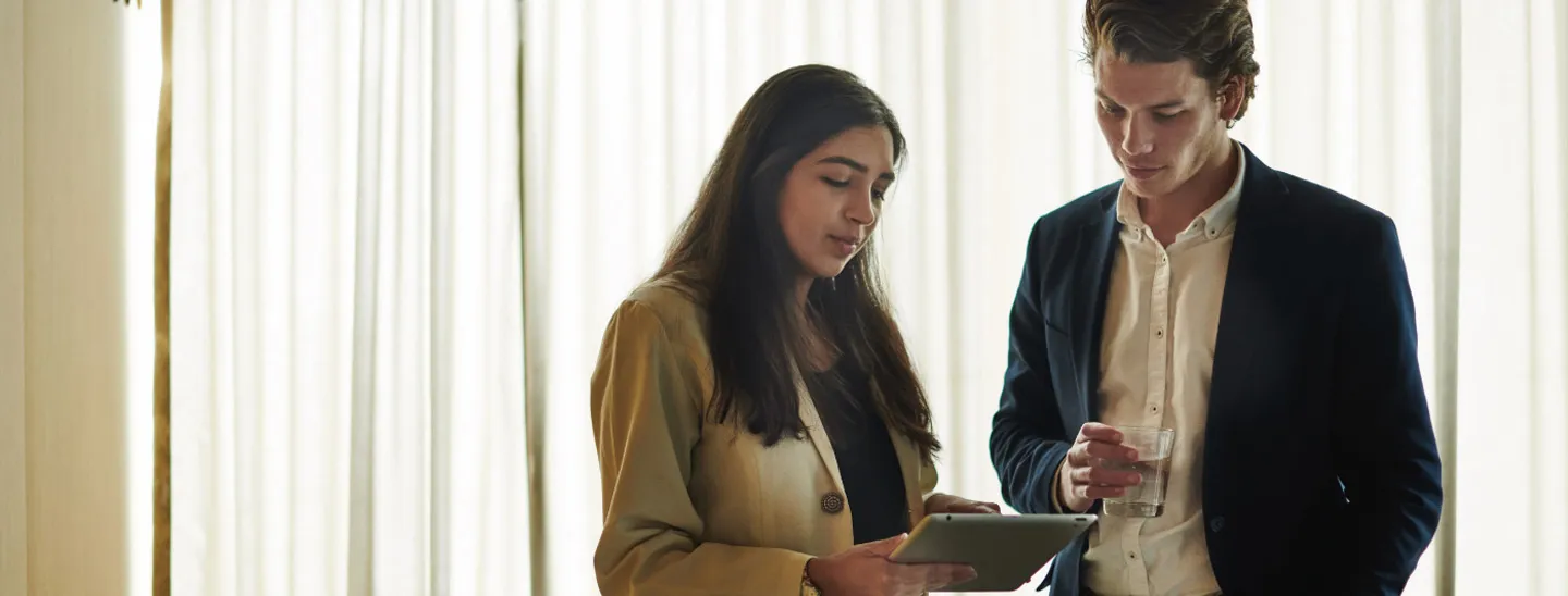 Campus couple looking at tablet device