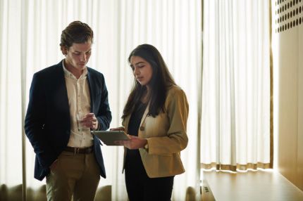 Campus couple looking at tablet device