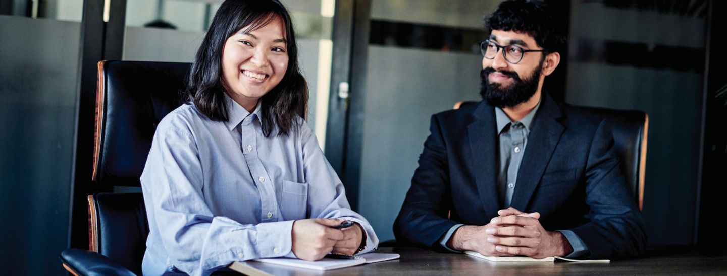 Campus couple sitting in boardroom