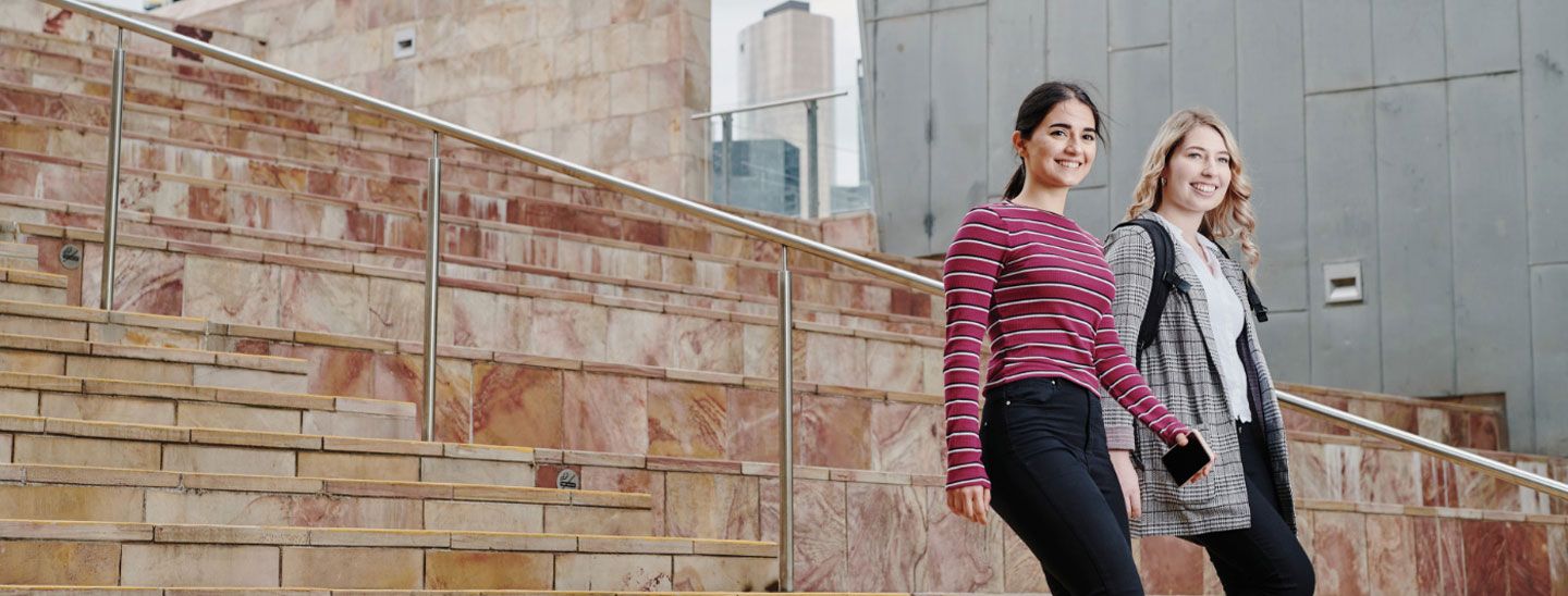Campus couple walking down stairs
