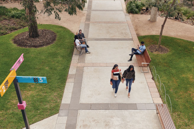Campus couple walking on pathway