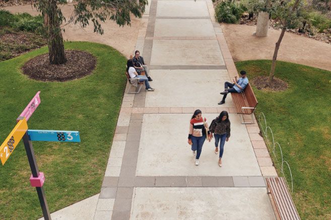 Campus couple walking on pathway
