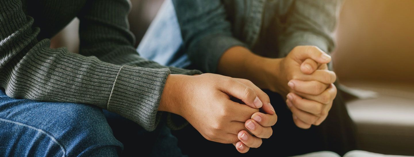 Campus couple with hands clasped