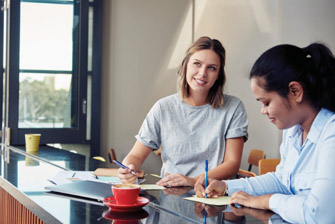Female couple writing notes