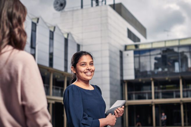 Campus female holding laptop
