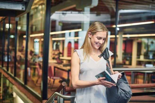Campus female reading notebook