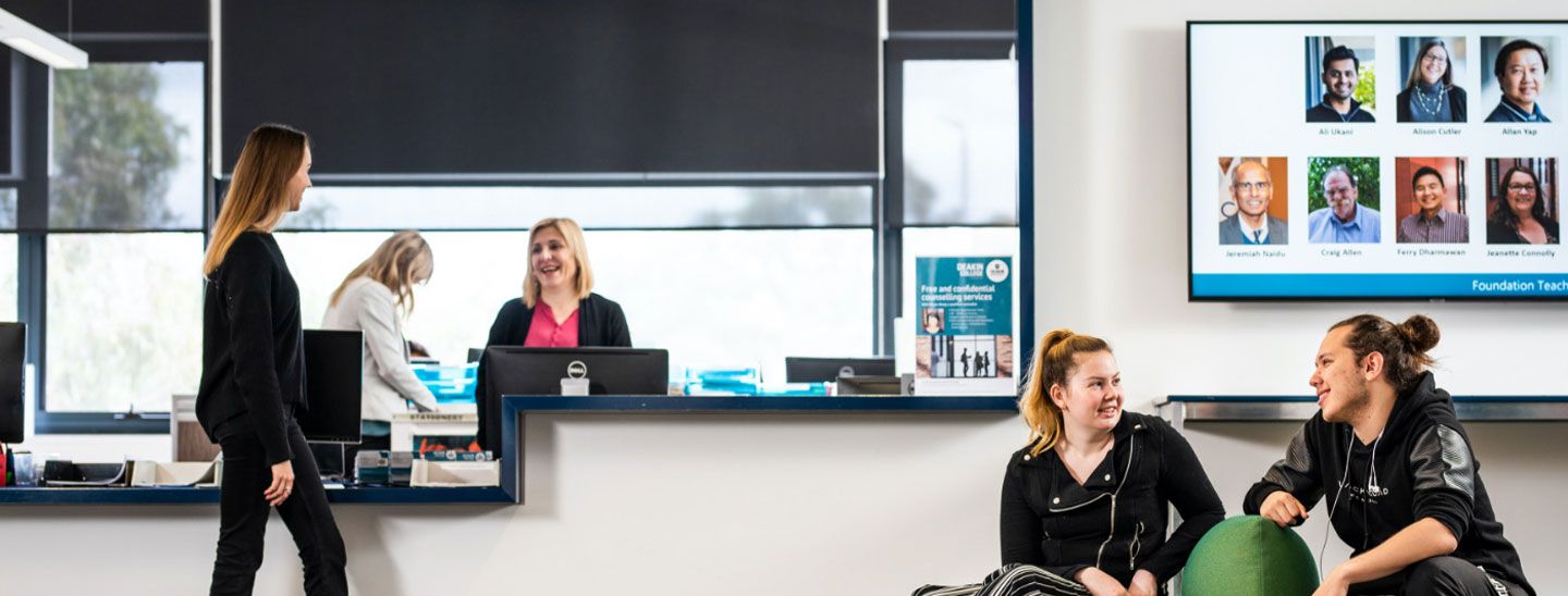 Campus group discussing at help desk