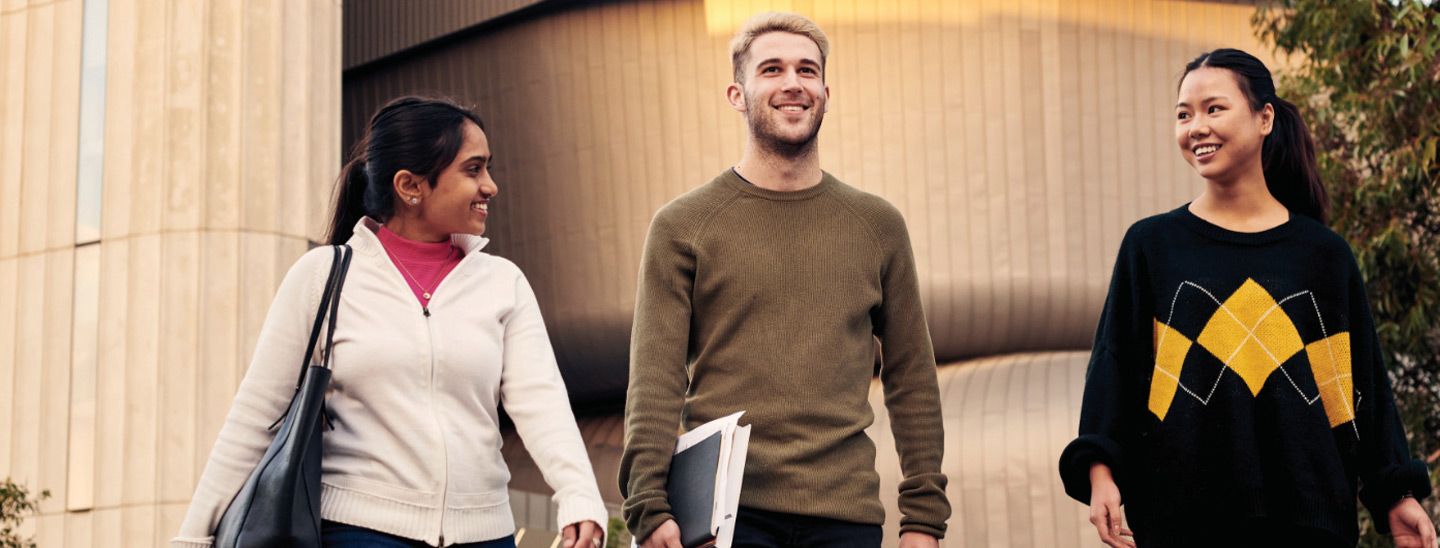 Campus group outside concrete building