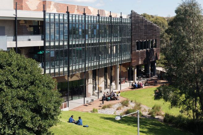 Campus group sitting outside building