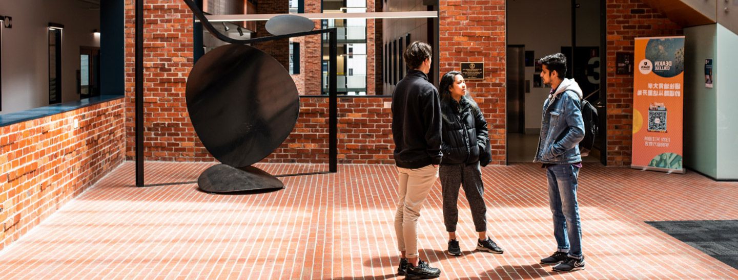 Campus group standing in front of brick building