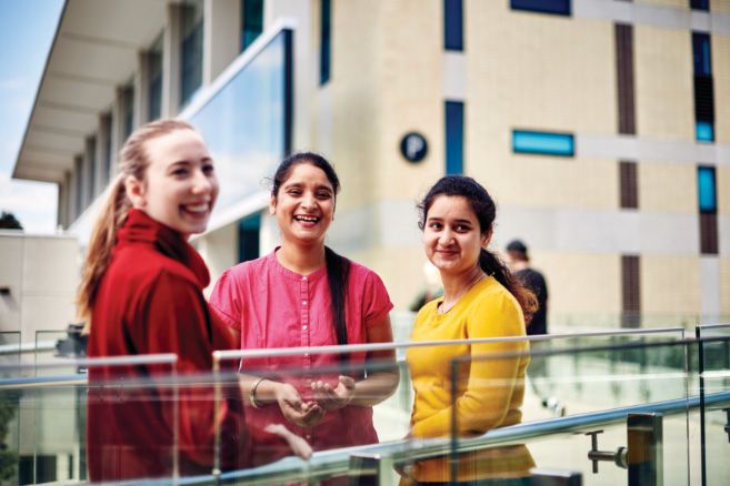Campus group standing next to railing