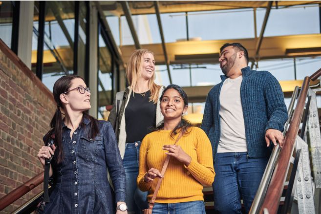 Campus group walking down staircase