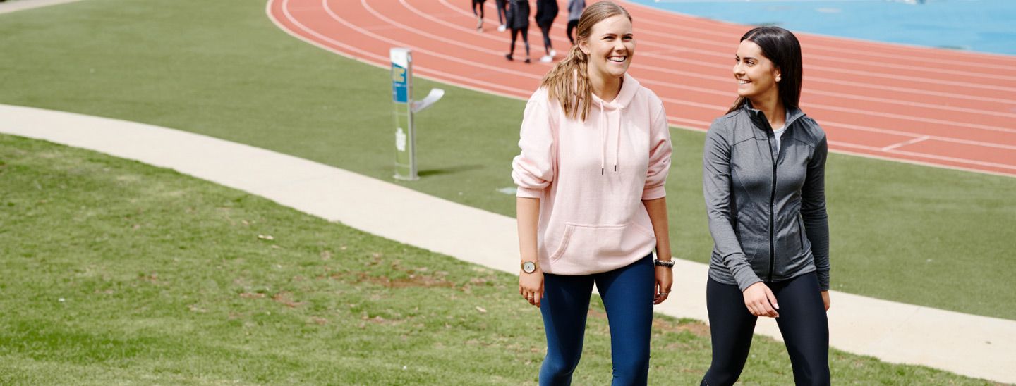 Campus group walking near running track