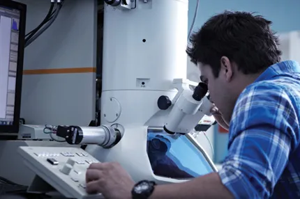 Campus male caucasian working with microscope