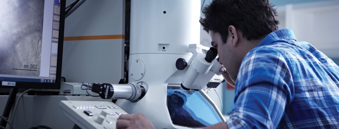 Campus male caucasian working with microscope