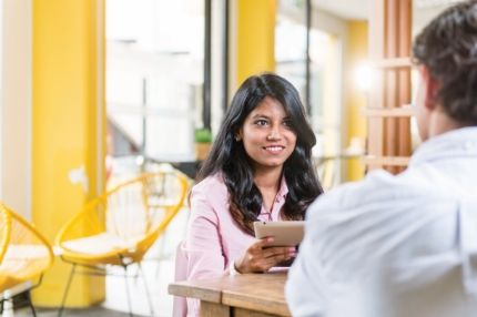 Female on ipad discussing