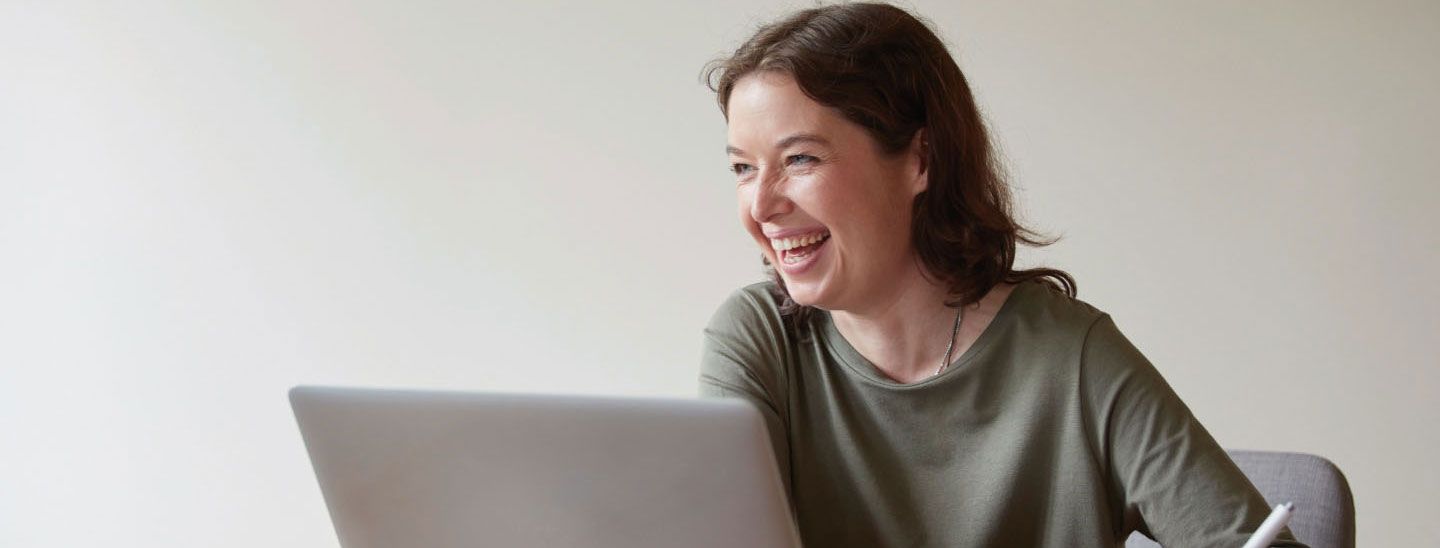 Female on laptop laughing