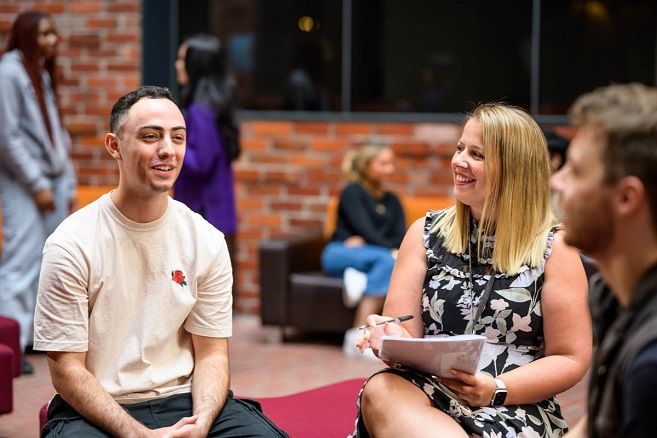Lady helping students