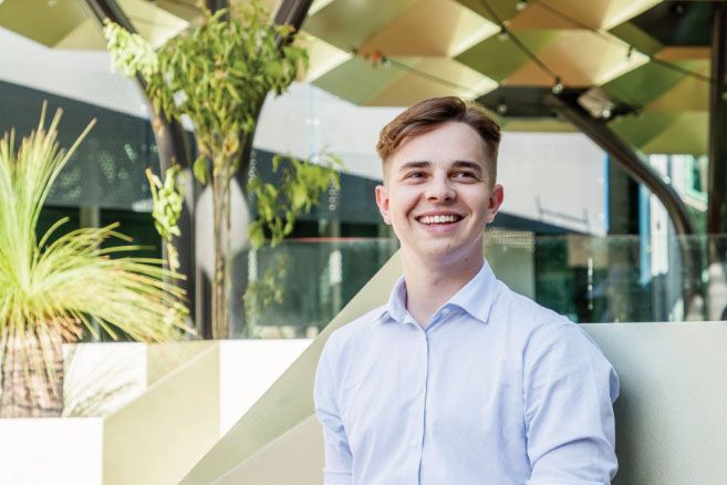 Male smiling on campus