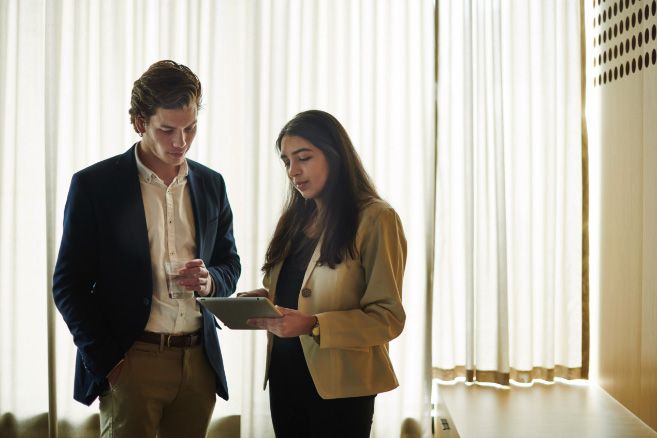 off campus couple looking at tablet device