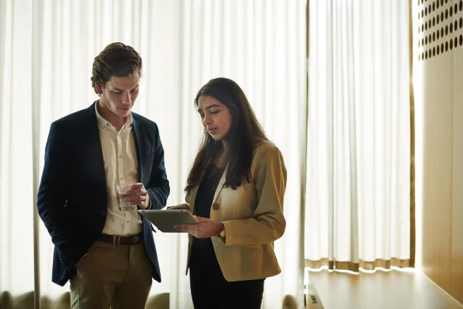 off campus couple looking at tablet device