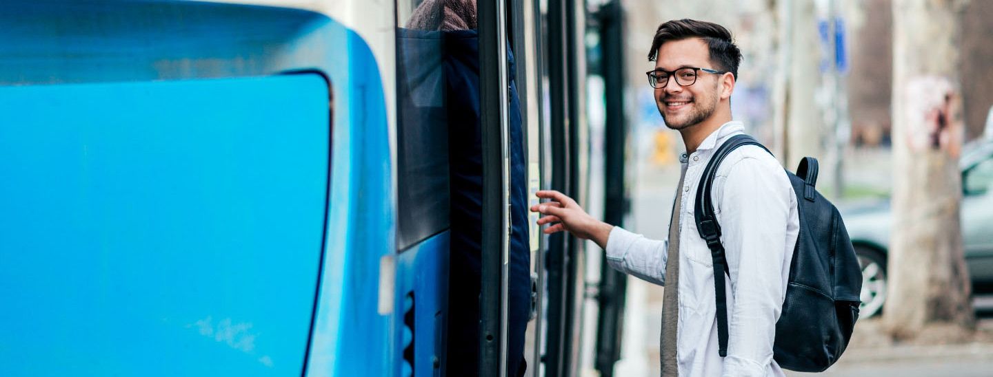 Off campus male getting on bus
