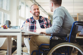 Off campus male on wheelchair talking to male