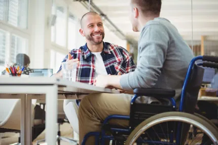 Off campus male on wheelchair talking to male