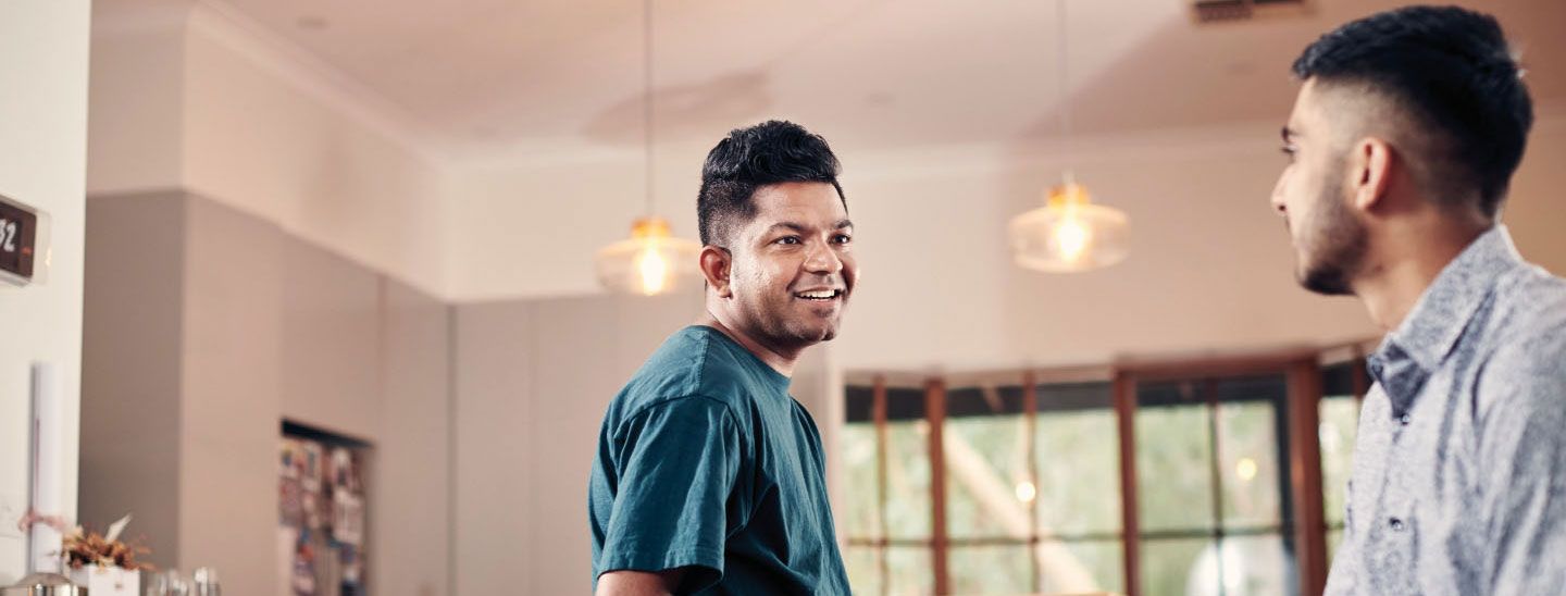 Off campus two males talking at home