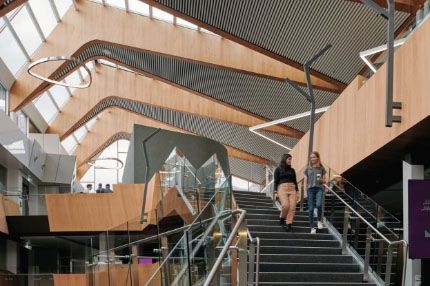 Two females walking down stairs at burwood campus