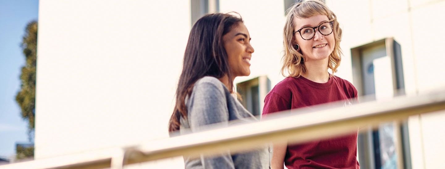 Two females walking up ramp